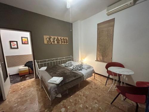 a bedroom with a bed and a table in it at Alloggio Desiri 2 in Pavia