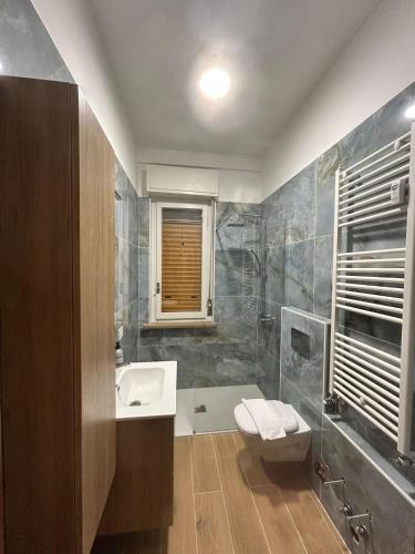 a bathroom with a sink and a toilet at Alloggio Desiri 2 in Pavia