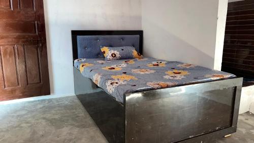 a bed with a bed frame in a room at Prime Hotel in Kannauj