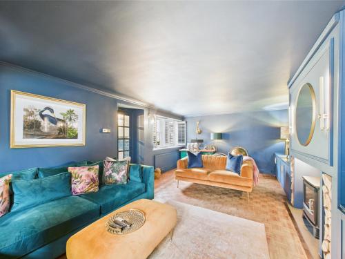 a living room with blue walls and a blue couch at Smithy Stables in Barnard Castle