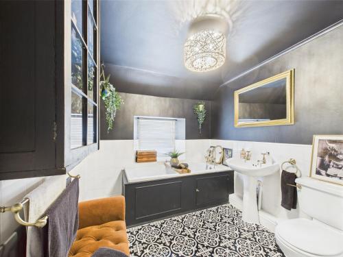 a bathroom with a tub and a sink and a toilet at Smithy Stables in Barnard Castle