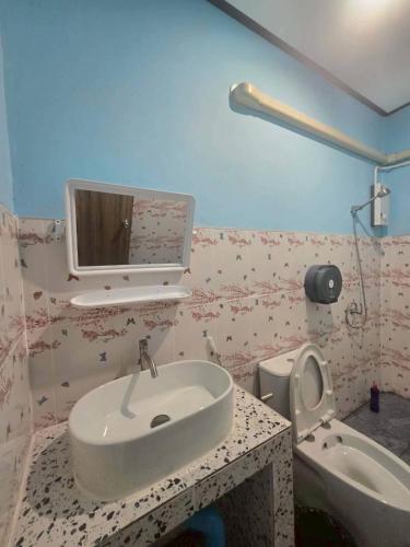 a bathroom with a sink and a toilet at Mook Lucky family in Ban Chao Mai