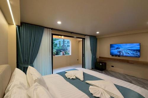 En eller flere senge i et værelse på Sand Maré Karon Hotel