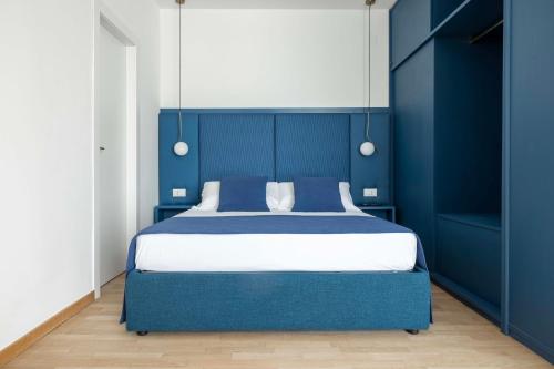 a blue bedroom with a large bed with blue walls at Boutique Hotel Maria Vittoria in Rome