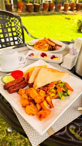 a plate of food with a sandwich and french fries at Rio Eco Gardens Hotel in Nairobi