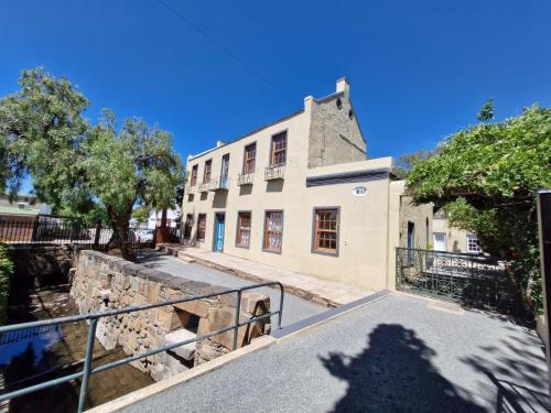 l'ombra di una persona che si trova di fronte a un edificio di Coniston Villa a Colesberg