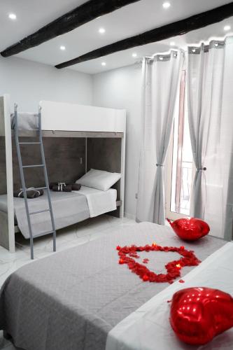 a bedroom with a bed with a red heart on it at B&B A Da Ziett Suite in Naples