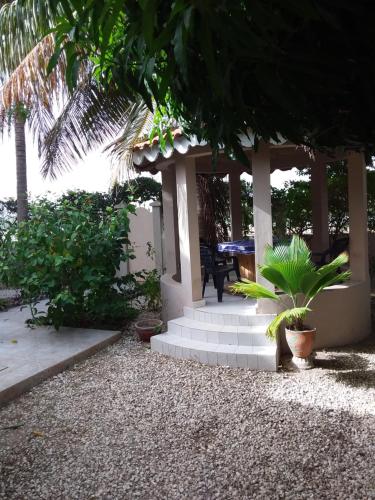 een huis met een veranda met een tafel en een aantal planten bij Résidence Diamane Sokone in Sokone