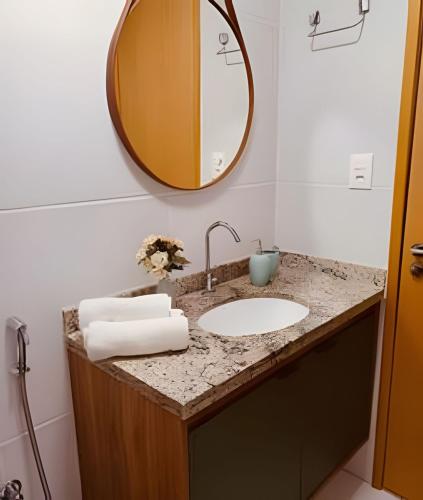 a bathroom with a sink and a mirror at Village Baixio Frente ao mar in Baixio