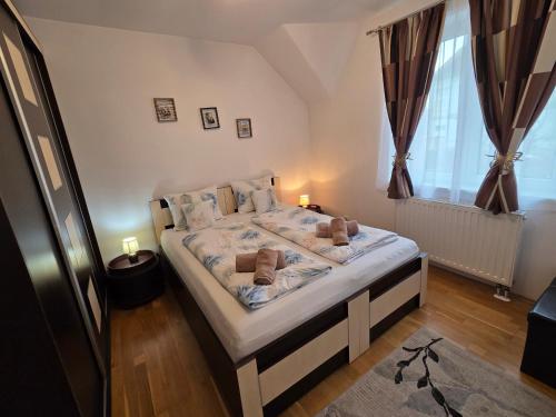 a bedroom with a bed with towels on it at Smiley Apartment in Sibiu