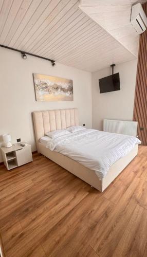 a bedroom with a large bed and a wooden floor at Yu-home 2 in Mukacheve