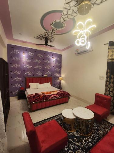 a bedroom with a bed and a couch and a chair at Dks villa Homestay in Agra