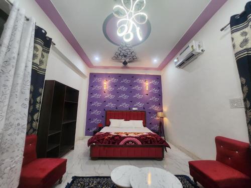 a bedroom with a bed with a purple wall at Dks villa Homestay in Agra