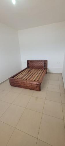 a bed sitting on a tiled floor in a room at Villa Alicia Vavindrano in Fort Dauphin