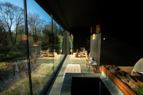 ein Glashaus mit Blick auf eine Terrasse in der Unterkunft Elements Lodges in Pettigoe