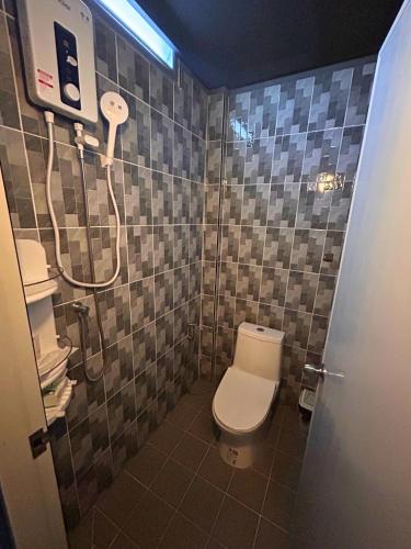 a bathroom with a toilet and a shower at Munchies Bed & Breakfast in Bangkok