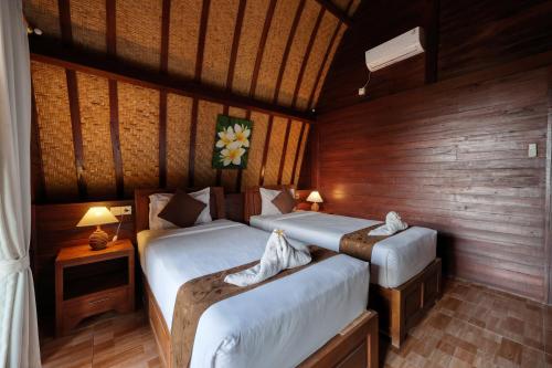 Postel nebo postele na pokoji v ubytování Bataran Garden Cottage