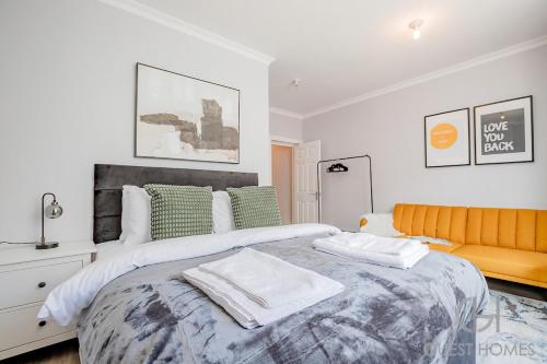 a bedroom with a large bed with two towels on it at Guest Stays - Bridge Street Studio 3 in Evesham