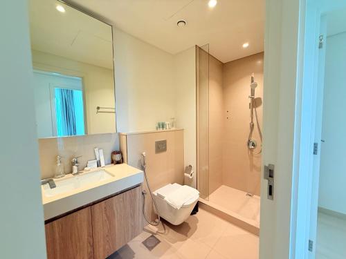 a bathroom with a sink and a toilet and a shower at Private Room in Luxury Burj Vista Apartment Downtown with Burj Khalifa View in Dubai