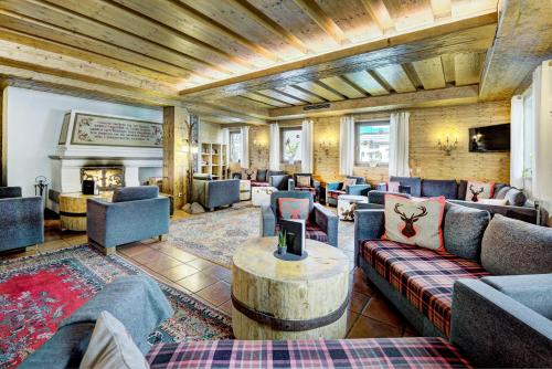 a large living room with couches and a fireplace at Hotel Unterhof in Filzmoos