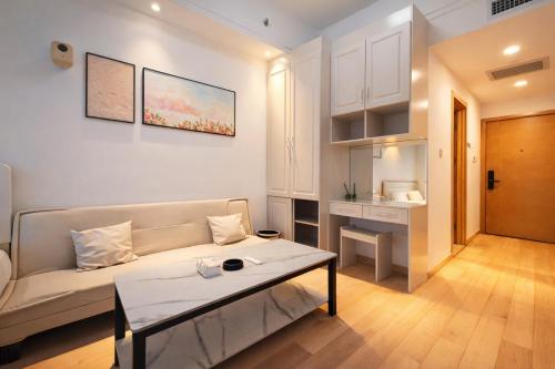 een woonkamer met een bank en een tafel bij B612 Residence in Kunming