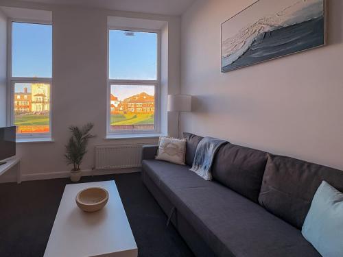 a living room with a couch and a coffee table at Euston Road - Beach Apartment 10 in Great Yarmouth