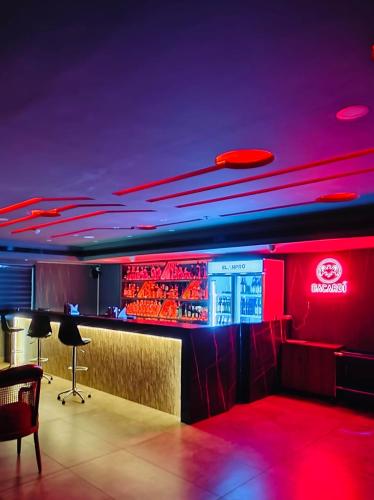 a nightclub with a bar with red lights at Golden Star in Kollam