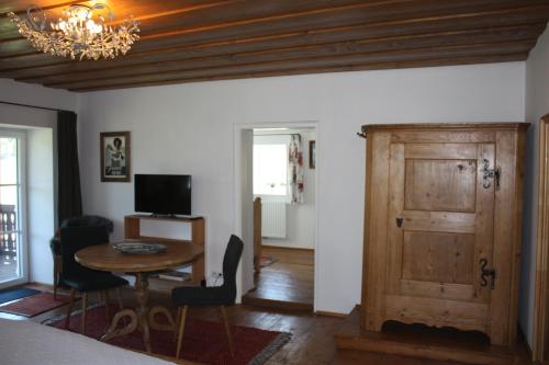 a room with a table and a wooden door at Landlust Ischl in Bad Ischl