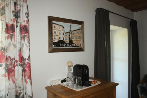 a mirror on a wall next to a dresser at Landlust Ischl in Bad Ischl