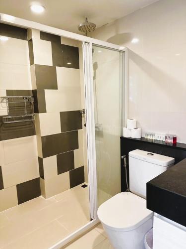 a bathroom with a toilet and a shower at Modern Condo in Nimman 501 in Chiang Mai