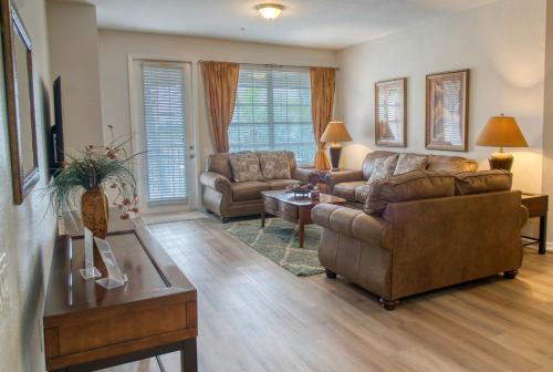 a living room with a couch and a table at Luxury Lake View Condo-Vista Cay in Orlando