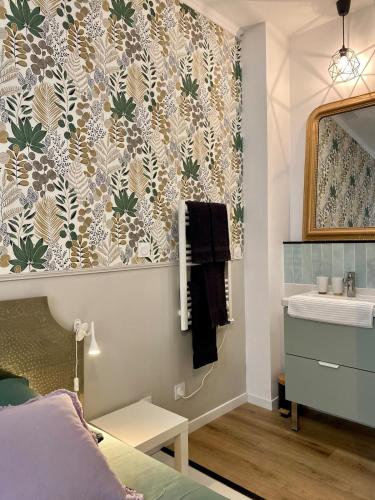 een badkamer met een wastafel en een spiegel bij La Parenthèse Champenoise in Épernay