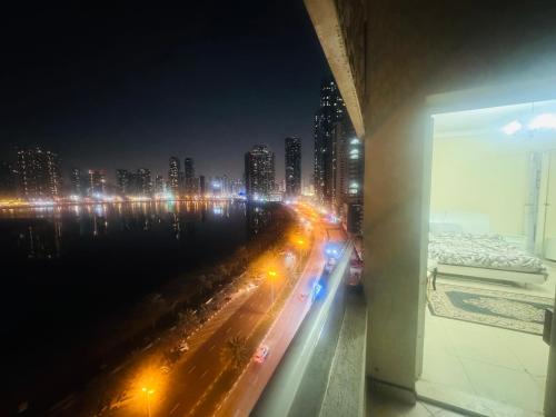 a view of a city at night with lights at Sryia 1 in Sharjah