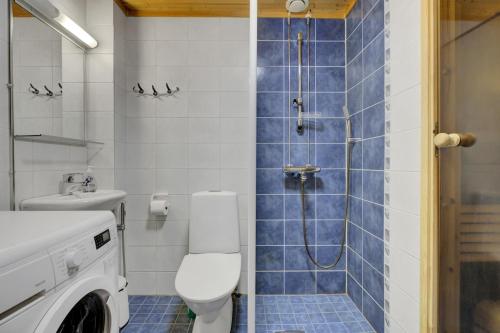 a bathroom with a shower and a toilet and a sink at Pyhäkoti A - 30 Meters From the Slopes - Valkea Homes in Pyhätunturi