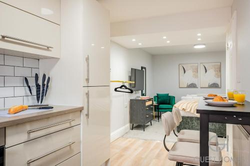 a kitchen and dining room with a counter and a table at Guest Stays - Bridge Street Studio 2 in Evesham