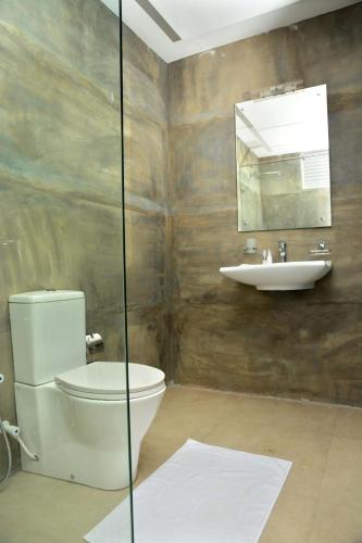 a bathroom with a toilet and a sink at Ayurvedic Beach Resort in Negombo