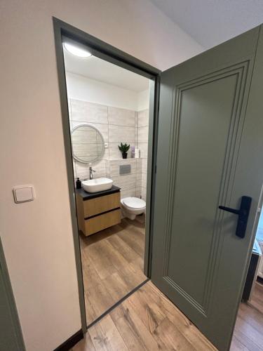 an open door to a bathroom with a toilet at Apartman nad Metují in Teplice nad Metují