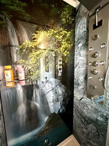 a picture of a waterfall in a bathroom with a waterfall at Optimus Mechernich in Mechernich