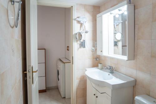 a bathroom with a sink and a mirror at Renas Guesthouse in Sitia