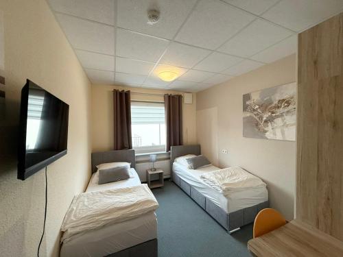 En eller flere senge i et værelse på GM Rooms in Laatzen bei Hannover