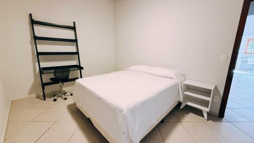 伊利亚贝拉佩里克旅馆的卧室里有一张白色的床和一把椅子