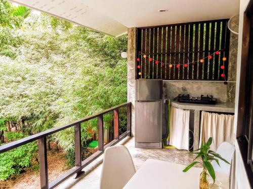 a patio with a table and chairs on a balcony at Feel Home in Hinkong