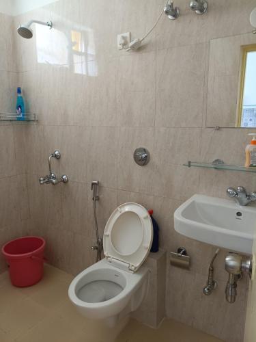 a bathroom with a toilet and a sink at Namaste sea view apartment in Canacona