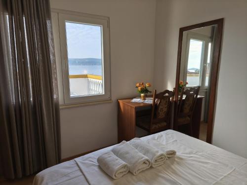 a bedroom with a bed with towels on it at Pansion Danilo by the sea in Krmčina