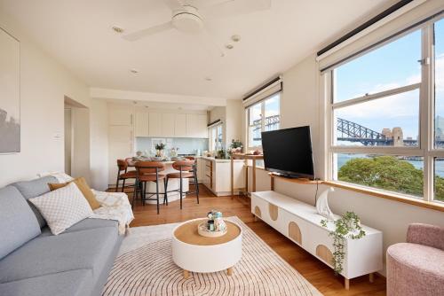 a living room with a couch and a table at Iconic 1 BR Harbour View Apartment in Sydney