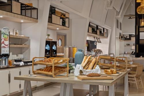 a bakery with bread and pastries on a table at Hilton Garden Inn Bordeaux Centre in Bordeaux