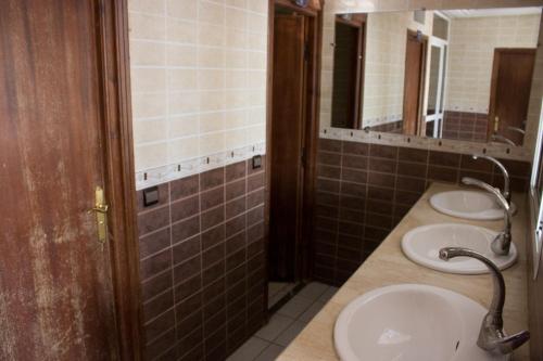 a bathroom with two sinks and two mirrors at Hotel Bab Boujloud in Fès