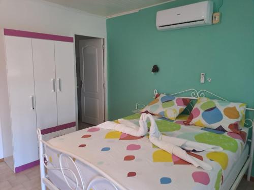 a bedroom with a bed with a polka dot blanket at Le Paradis bleu in Sainte-Anne