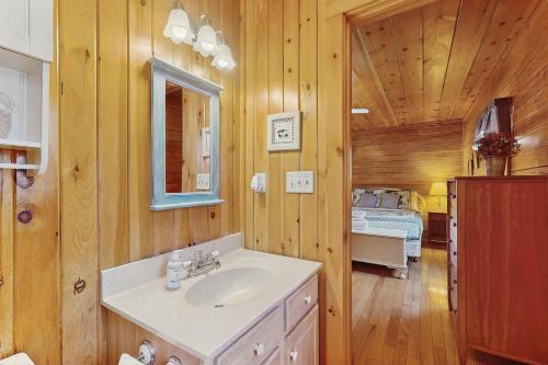 een badkamer met een wastafel en een bed in een kamer bij Chimney Hill Retreat in Wilmington