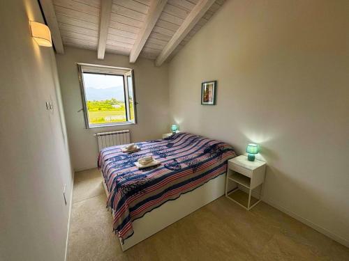 a small bedroom with a bed and a window at -La Bella Ameglia- Private Parking in Luni